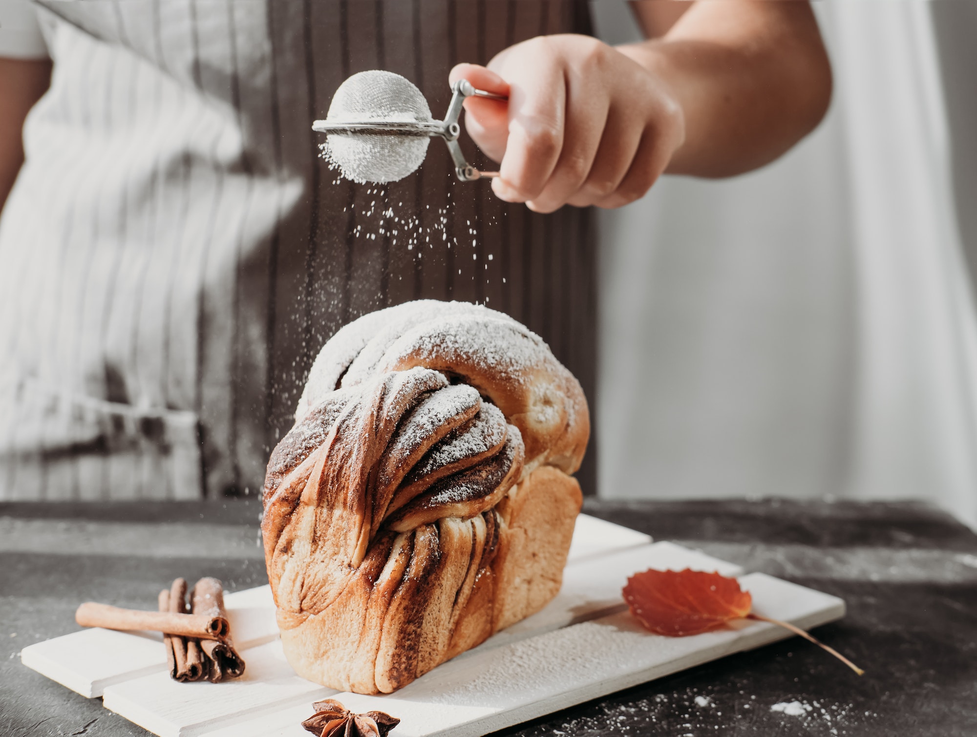 artisan sourdough cinnamon swirl bread on wooden rack