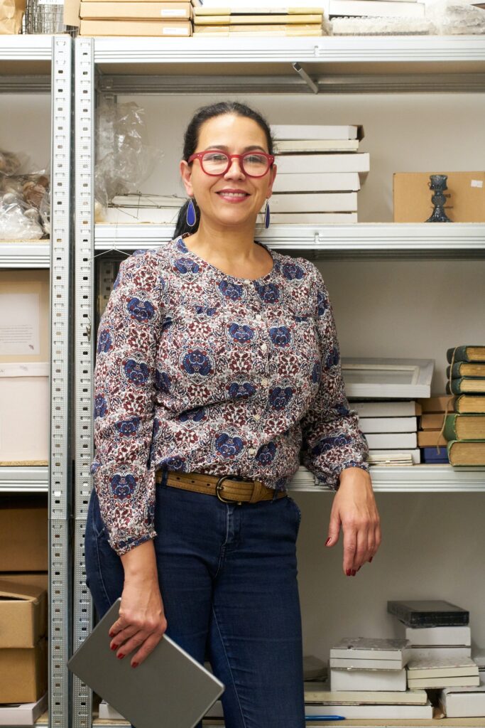 Portrait of female small business owner in gift shop stockroom